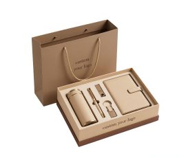 Corporate gift notebook set with custom QYC logo, leather cover, and premium packaging box.