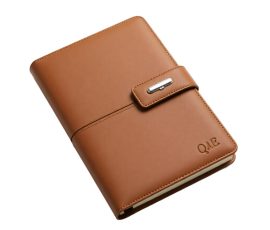 Caramel brown genuine leather notebook with laser engraved QYC logo, luxury corporate gift.